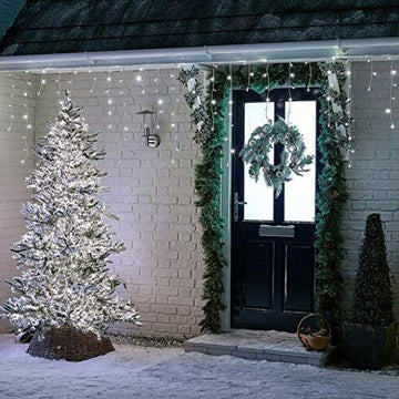 white icicle lights hung on home roofline